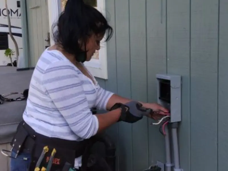 Licensed electrician wiring an exterior subpanel in Broadalbin